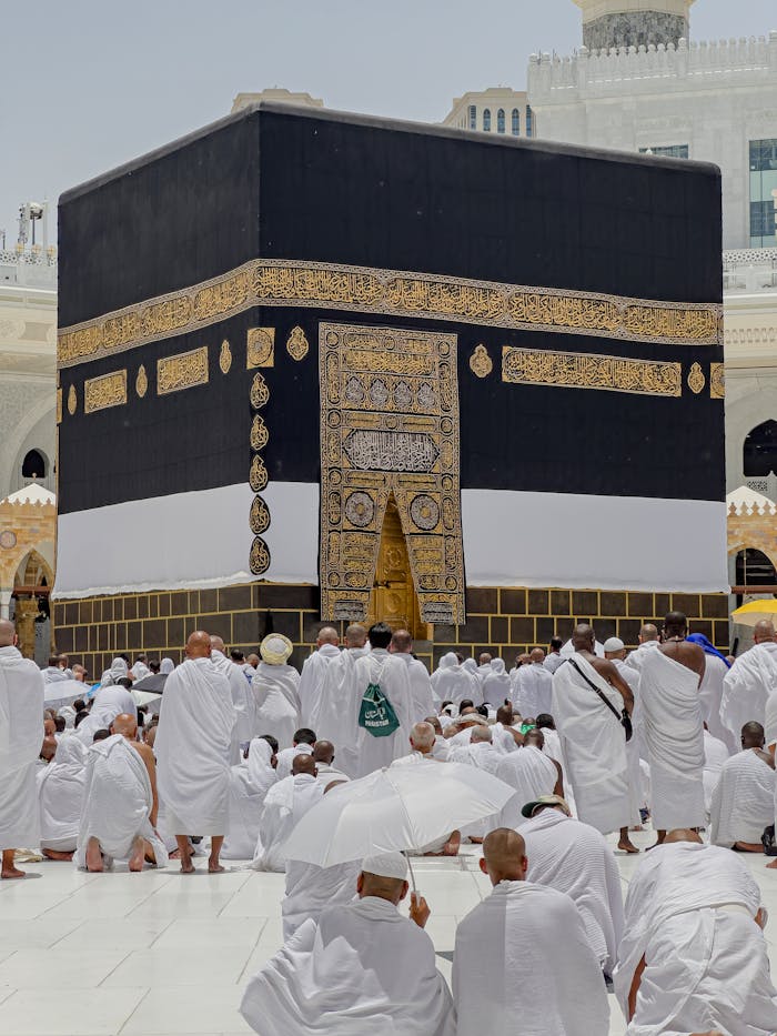 gallery-5 Pilgrims in white garments gather around the Kaaba in Mecca during daytime prayers.